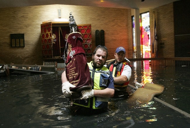 Members of ZAKA rescuing a Torah from Congregation Beth Israel after Hurricane Katrina hit, August 2005. (Courtesy ZAKA)
