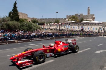 A Formula 1 Ferrari race car driving through the Old City during the Jerusalem Formula Peace Road Show, June 14, 2013. (Flash 90)
