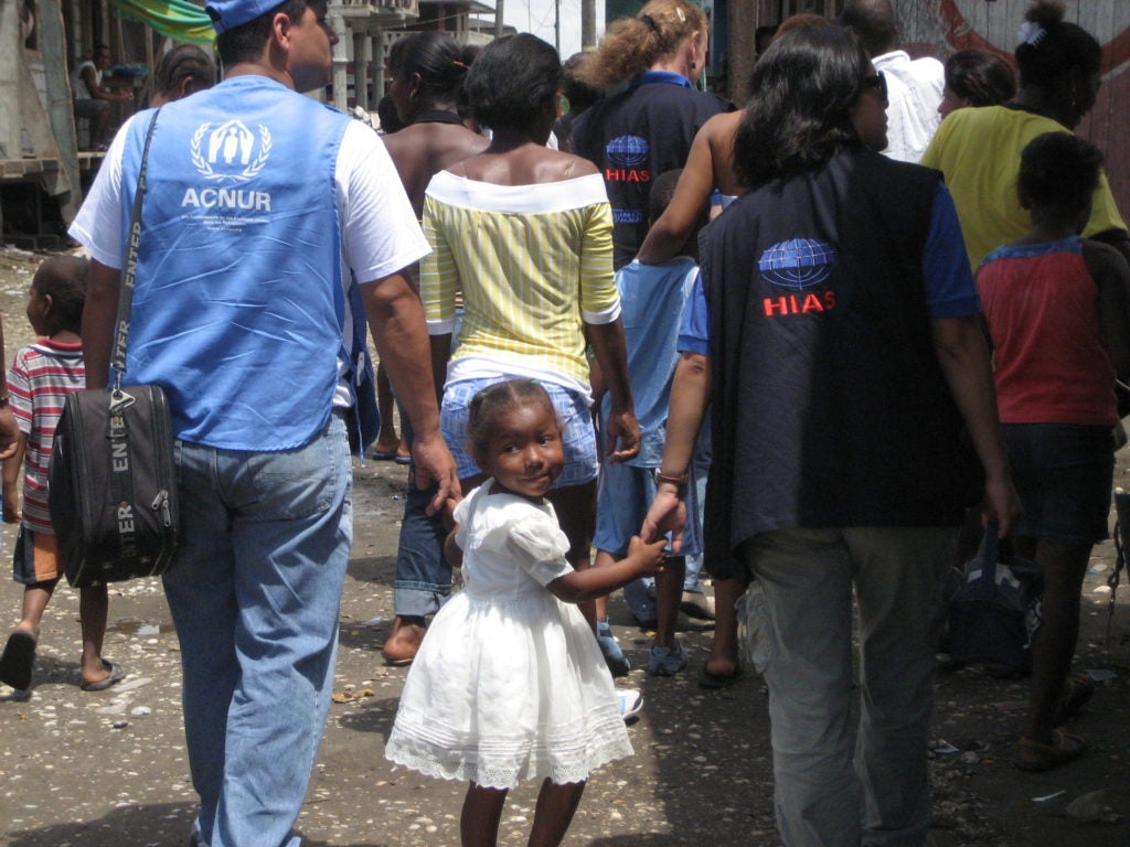 A young girl in Ecuador holding hands with representatives of HIAS, right, and the refugee agency of the United Nations. (Courtesy HIAS)