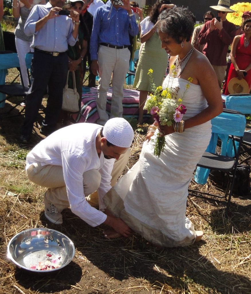 Micha'el BedarShah washes the feet of his bride, Aumatma, during the first wedding ceremony held at Urban Adamah, a Jewish educational farm in Berkeley, Calif., June 30, 2013. (Photos courtesy Micha'el BedarShah)