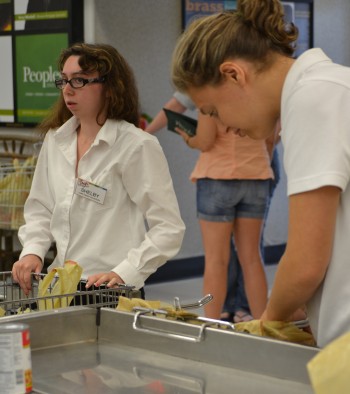 Atzmayim participants Rachel Palmer (right) and Shelby Marcus bag groceries at Trig's, a supermarket in Eagle River, Wis. (Courtesy of Ramah Wisconsin)