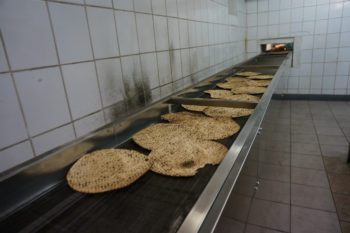 Matzahs on the production line of the Tiferet HaMatzot factory in Dnepropetrovsk on Dec. 8, 2014. (Cnaan Liphshiz/JTA)