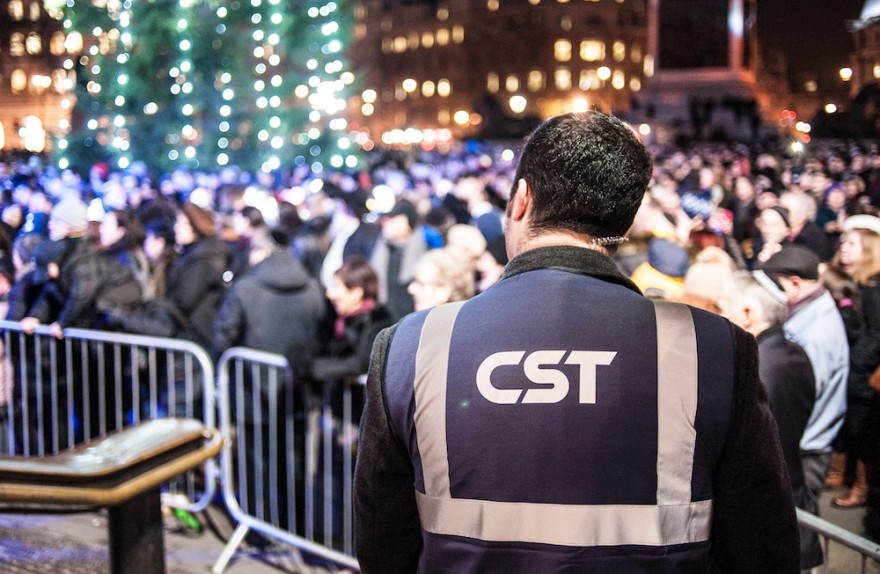 A Community Security Trust guard keeps watch over a Hanukkah celebration in London in 2014. (Blake Ezra Photography)