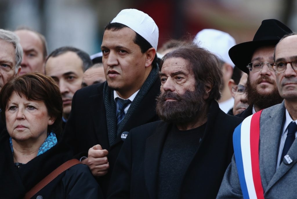 Marek Halter, second from right, and Hassen Chalghoumi, in white cap, at a mass rally in Paris following the shootings at the Charlie Hebdo magazine and the Hyper Cacher supermarket, Jan. 11, 2015. (Dan Kitwood/Getty Images)