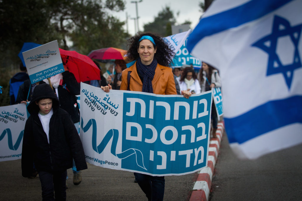 Women from the ' Women Wage Peace ' movement demonstrate outside the Knesset March 4, 2015. (Miriam Alster/Flash90)
