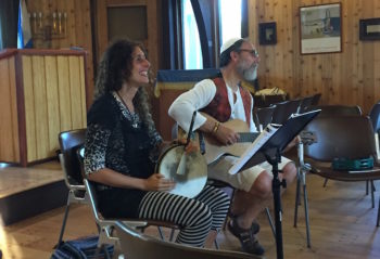 Basya Schechter and Shaul Magid, preparing to welcome congregants to an interactive Shabbat service. (Batya Ungar-Sargon)