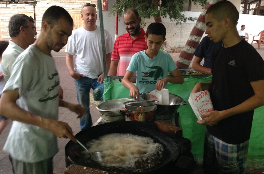 Vendors sell falafel at the nightly Ramadan market in Kfar Qasim. (Ben Sales)