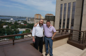 Director of the Jewish Community of Dneproptrovsk, Zelig Brez, left, and local donor Natan Zolotarevsky on the roof of the Menorah Center on July 15, 2014. (Cnaan Liphshiz)
