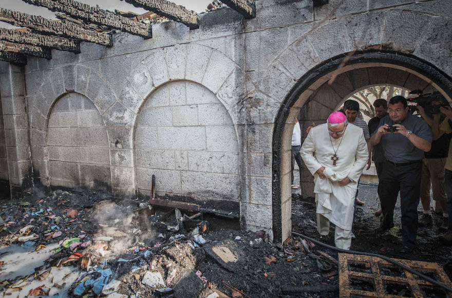 Giacinto-Boulos Marcuzzo, the Roman Catholic Auxiliary Bishop of the Latin Patriarch of Jerusalem, inspecting the torched Church of the Multiplication at Tabgha, June 18, 2015. (Basel Awidat/Flash90)