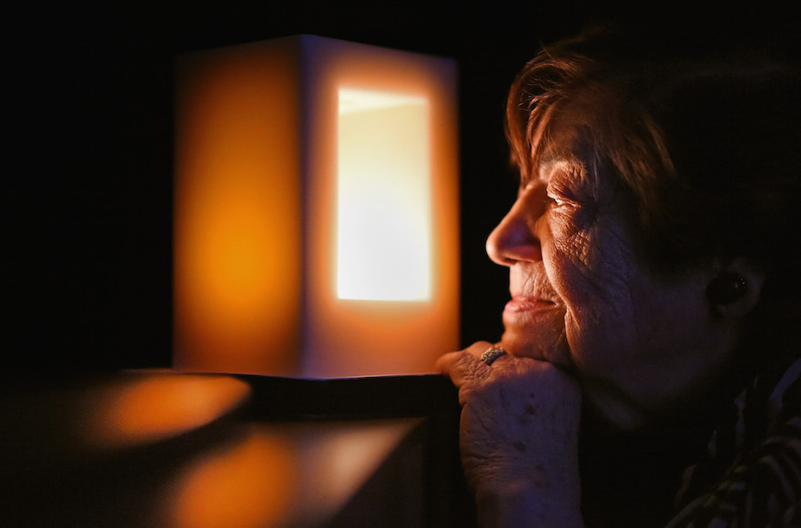 A Holocaust survivor looks at a candle commemorating the liberation of Auschwitz Birkenau, January 27, 2015, in Ayr, Scotland. (Jeff J. Mitchell/Getty Images)