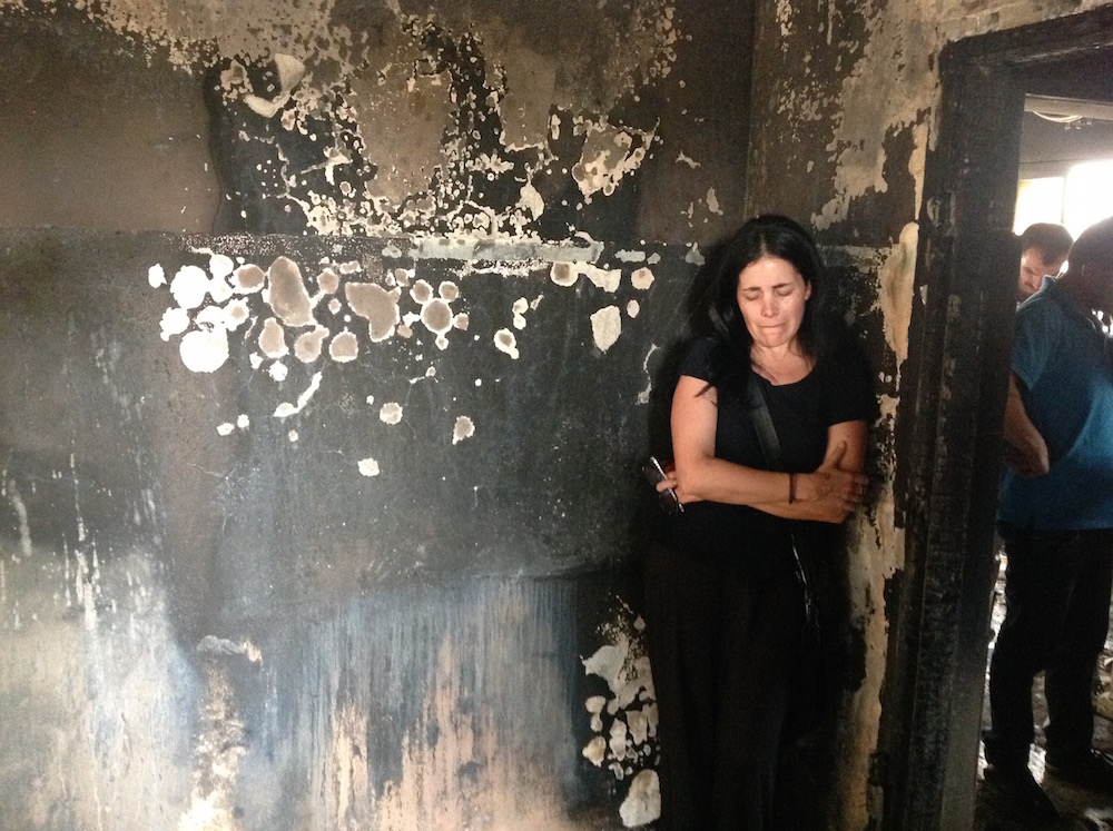Tali Mizrahi, a member of the anti-racism group Light Tag, visiting the home of a Palestinian baby allegedly killed by Jewish arsonists. (Ben Sales)