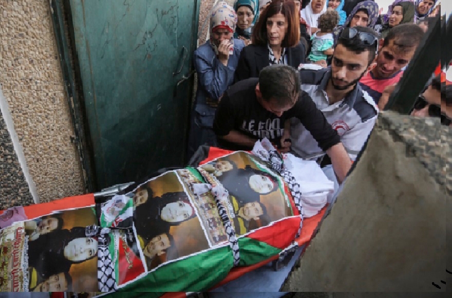 Palestinian mourners carry the body of Riham Dawabsha, whose baby son and husband were killed in the July firebombing of the family's home, during her funeral at the cemetery in the West Bank village of Duma, Sept. 7, 2015. (Flash90)