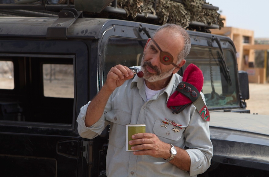 An Israeli army officer eating falafel in a scene from "Atomic Falafel." (Courtesy of Dror Shaul)