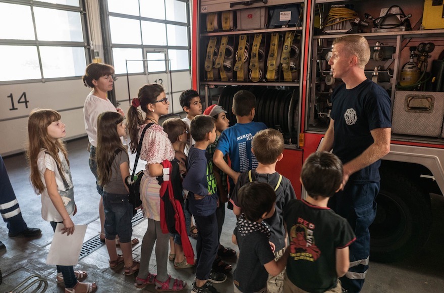 Refugee children visiting a fire department in Berlin. (Judith Kessler)