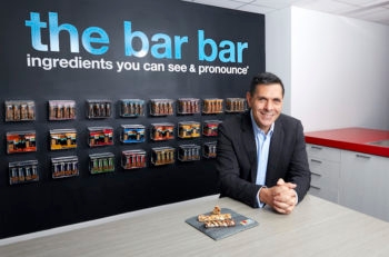 Daniel Lubetzky in the kitchen area of the KIND office in New York City, which is full of various flavors of KIND bars. (Poon Watchara-Amhaiwan)