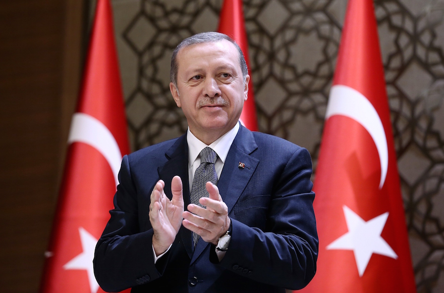 Turkish President Recep Tayyip Erdogan clapping during the 2015 Turkish Academy of Sciences award ceremony at Presidential Complex in Ankara, Turkey, Dec. 14, 2015. (Yasin Bulbul/Presidency/Anadolu Agency/Getty Images)