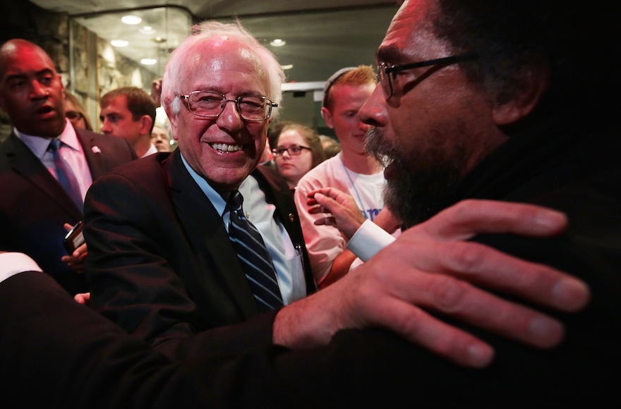 Philosopher Cornel West, right, embracing Democratic presidential candidate  Bernie Sanders in Des Moines, Iowa, Nov. 14, 2015. (Photo by Alex Wong/Getty Images)