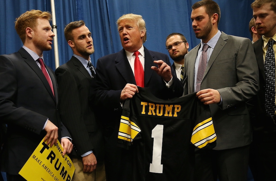 Republican presidential candidate Donald Trump talking with University of Iowa football players during a campaign event in Iowa City, Jan. 26, 2015. (Joe Raedle/Getty Images)