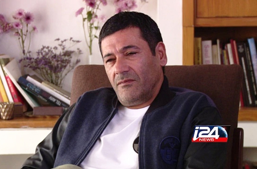 Gilbert Chikli giving an interview at his Ashdod home, Dec. 29, 2015. (Courtesy of i24 News)