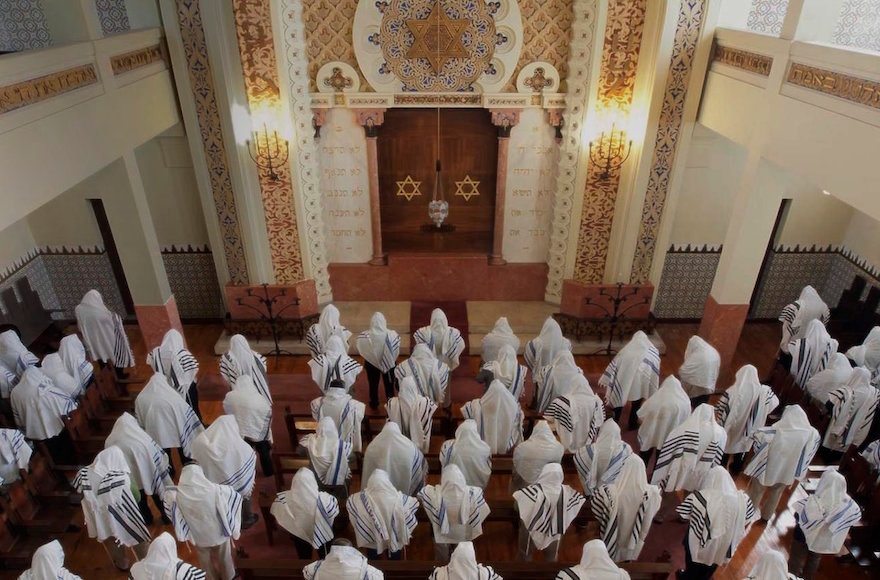Congregants praying at the Kadoorie - Mekor Haim synagogue in Porto, Portugal, May 2014. (Courtesy of the Jewish Community of Porto)