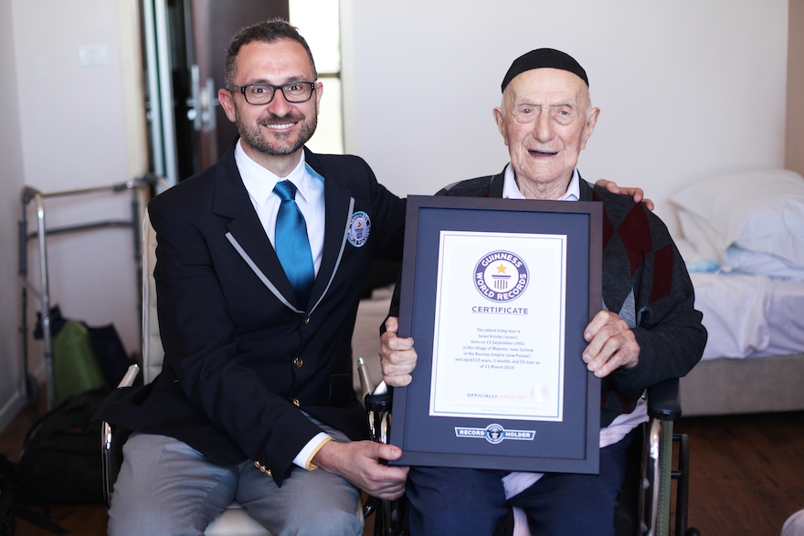 Marco Frigatti, Head of Records for Guinness World Records, presents Israel Kristal his certificate of achievement for Oldest living man on 11th March 2016, Haifa. (Courtesy of Guinness World Records)