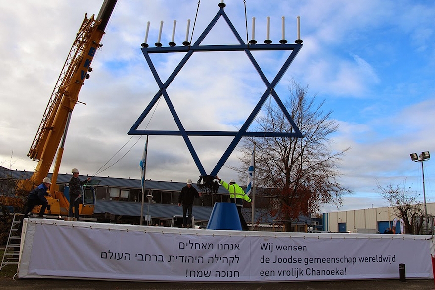 Workers installing a 36-foot menorah outside the Dutch headquarters of Christians for Israel, December 2013. (Courtesy of Christians for Israel)