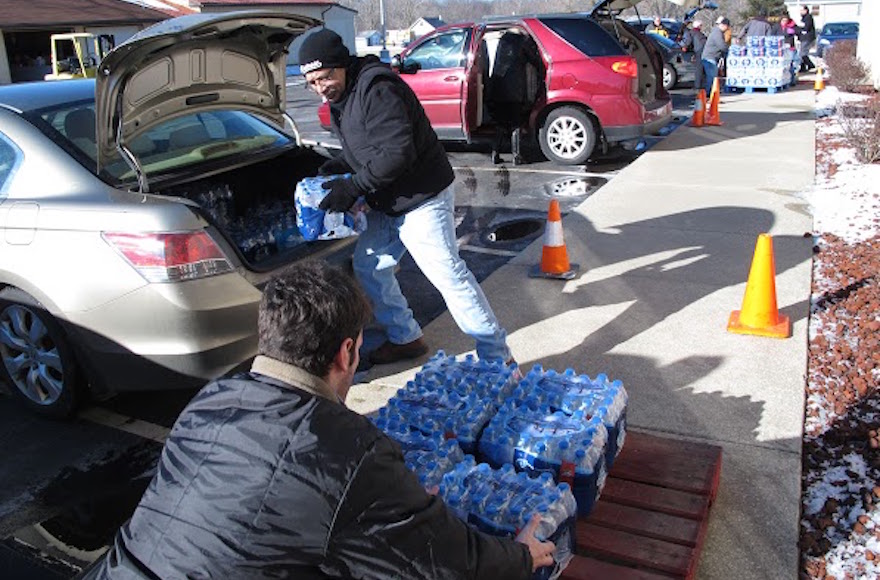 Volunteers offloading water donated by the Flint Jewish community to a local church. (Courtesy of Flint Jewish Federation)