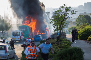 Firefighters and rescue personnel responding to a bus bombing in Jerusalem, April 18, 2016. (Nati Shohat/FLAsh90)