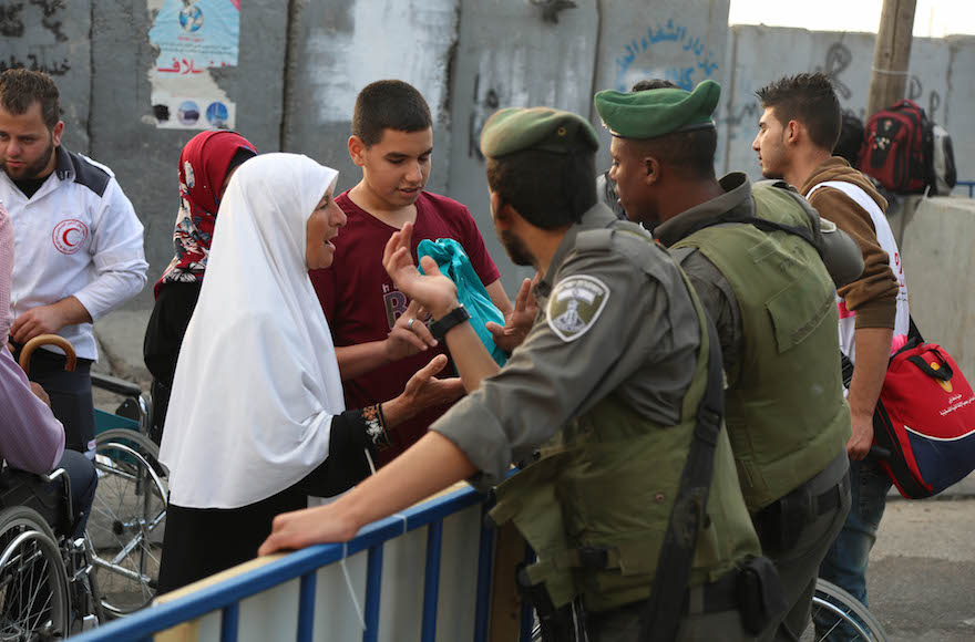 Palestinian women trying to cross the Qalandiya checkpoint on their way to Friday prayers at the Al-Aqsa Mosque in the second week of Ramadan in the West Bank city of Al-Ram, June 26, 2015. (Flash90)