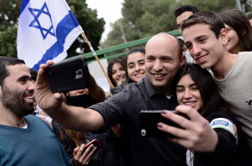 Naftali Bennett taking selfies with students at Bleich High School in the central Israeli city of Ramat Gan, Feb. 12 2015. (Tomer Neuberg/Flash90)