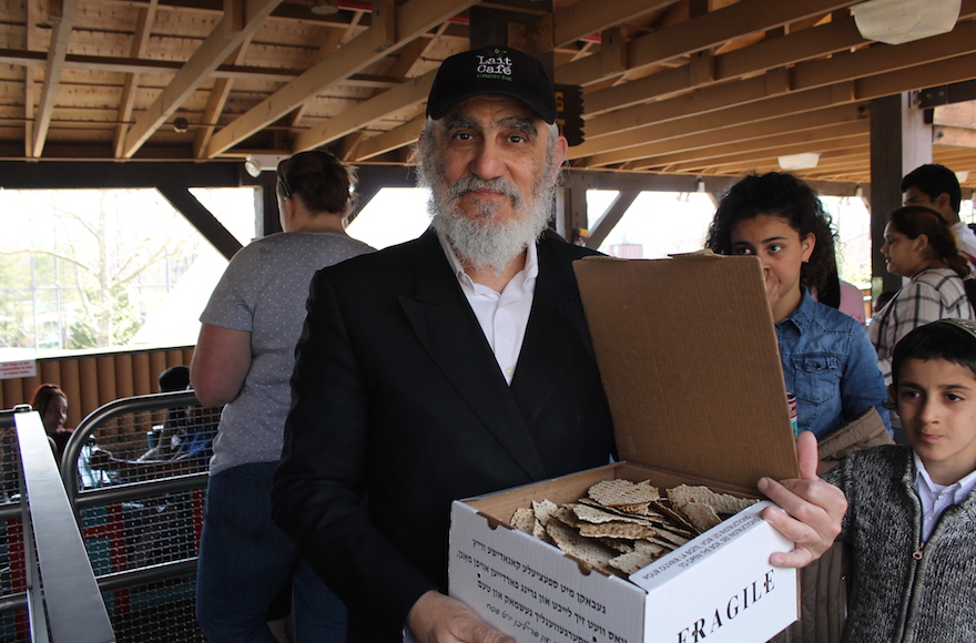 Pinchas Cohen, a restaurateur and father of nine from Brooklyn, brought his own box of handmade shmura matzah to the amusement park for Passover, April 25, 2016. (Uriel Heilman)