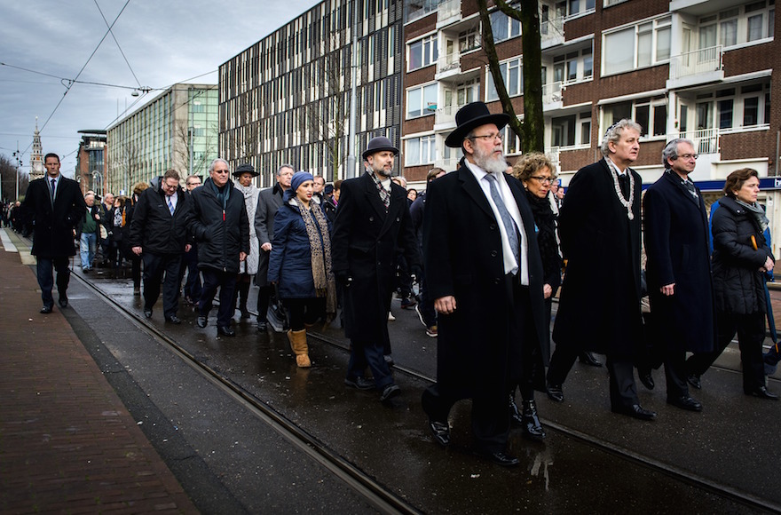 Mayor of Amsterdam Eberhard van der Laan, fourth from right, leading a march from City Hall to the Auschwitz monument in the Wertheimpark on the national memorial for the victims of the Holocaust in Amsterdam, Jan. 26, 2014. (Remko de Waal/AFP/Getty Images)