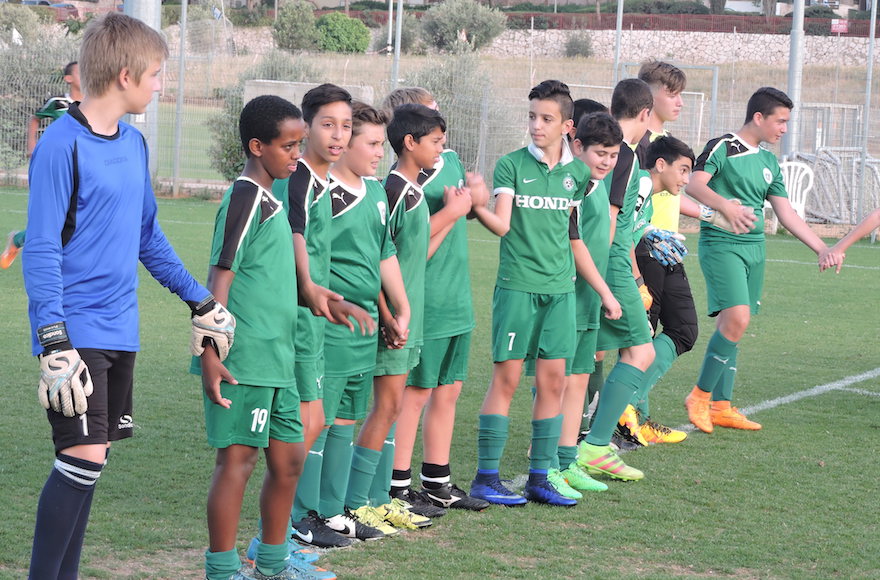 Members of the Tzav Pius 13-year-old team in the Israeli city of Pardes Hanna participate in an educational exercise meant to teach teamwork before a practice.  (Ben Sales)