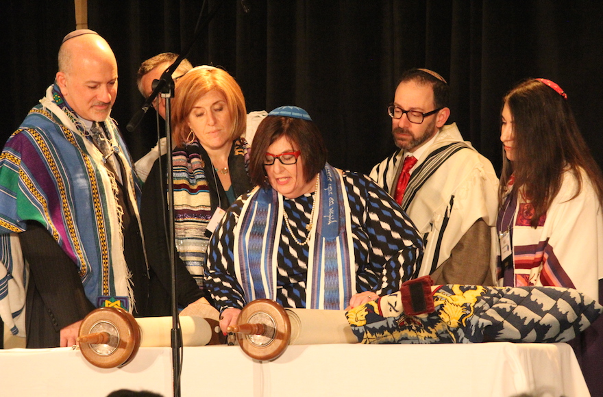Rabbi Denise Eger, center, reading Torah during her installation as CCAR president, March 16, 2015. (David A.M. Wilensky)