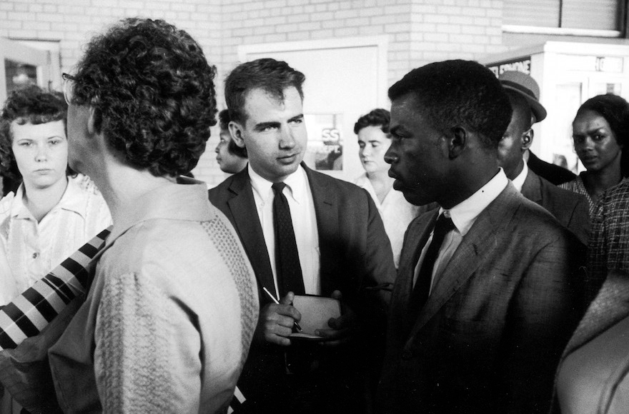 Writer Calvin Trillin, center, interviewing John Lewis in Birmingham, Ala., as the Freedom Riders were boarding the bus for Montgomery in 1961. (LIFE Images Collection)