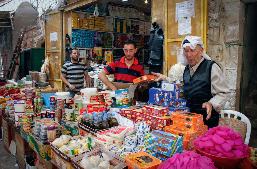 Palestinian vendors selling goods ahead of the holy month of Ramadan in the old city of the West Bank city of Hebron, June 5, 2016. (Wisam Hashlamoun/Flash90)
