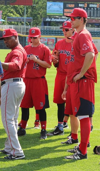 Nate Freiman, right, with some Portland Sea Dogs teammates and manager Carlos Febles, left, prior to a game, May 2016. (Hillel Kuttler)