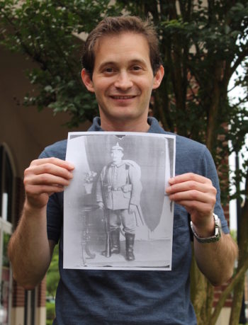 Baltimore jeweler Noam Efron holding a copy of the portrait he found of Siegfried Lamm at an estate sale for $9. (Hillel Kuttler)
