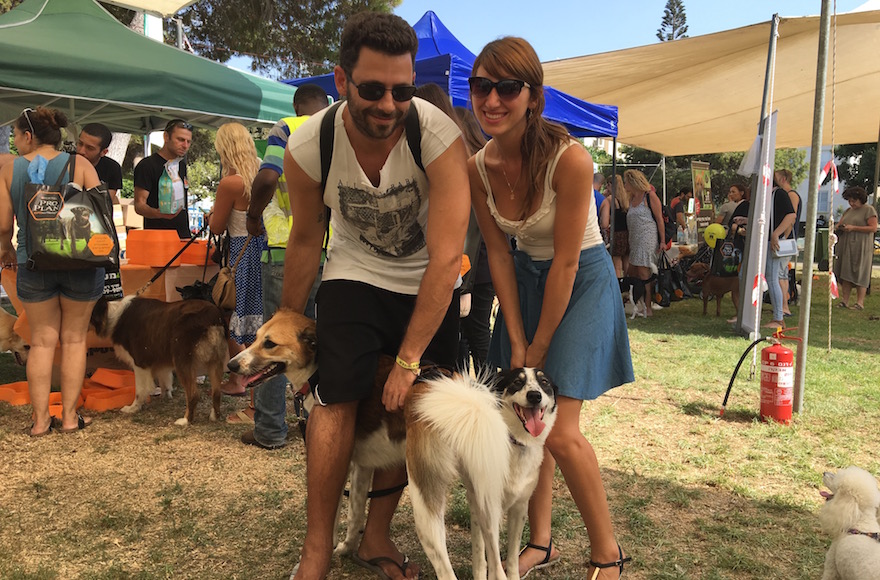 Hod Kashtan, left, with his dog Chuni, and Florencia Aventuriny with her dog Sandy at the Kelaviv dog festival in Tel Aviv, Aug. 26, 2016. (Andrew Tobin) 