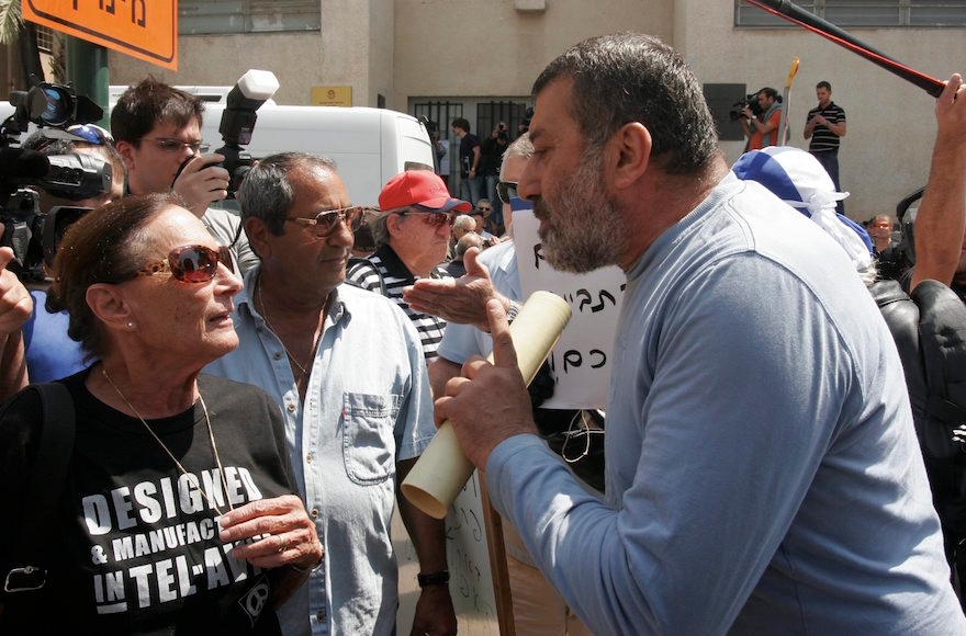 Israeli left wing and right wing activists demonstrating in Tel Aviv, April 21, 2011. (Roni Schutzer/Flash90)