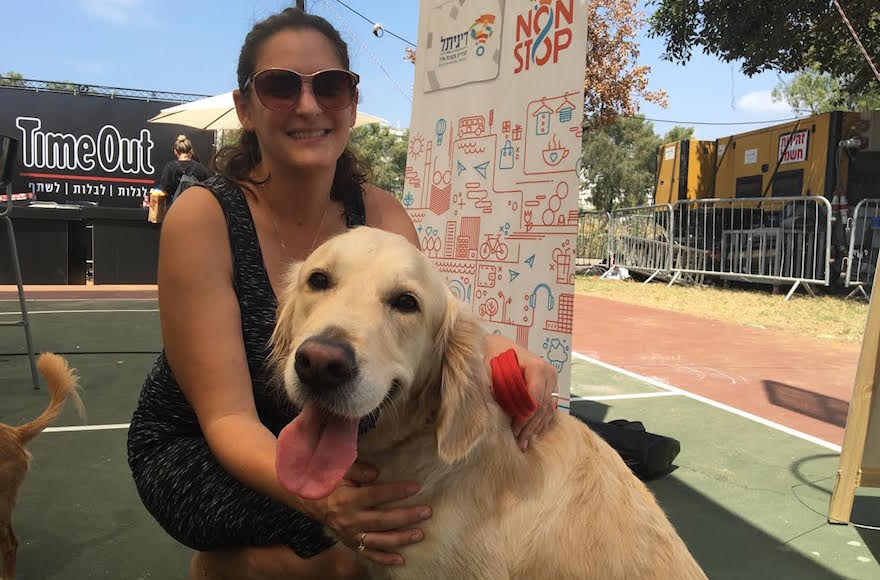 Mira Marcus, the city of Tel Aviv's director of international press, with her dog Shani at the Kelaviv dog festival in Tel Aviv, Aug. 26, 2016. (Andrew Tobin)