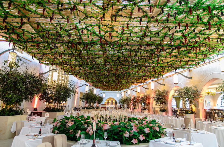 In 2015, this Studio Ya Ya-designed sukkah — one of four at the Waldorf Astoria Jerusalem — found inspiration in the atrium's existing flowers and water fountain. (Courtesy of Yarok Yarok Events Design)