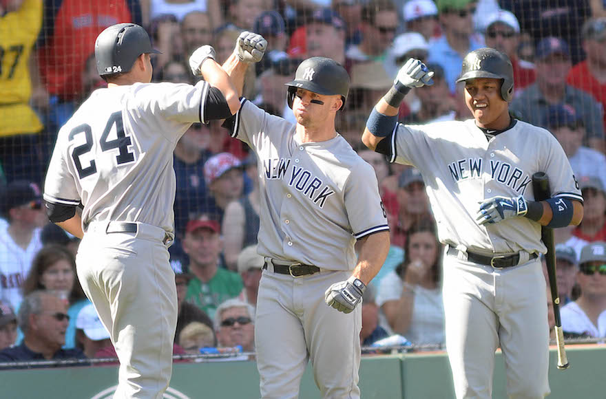 Gary Sanchez, left, high-fiving teammates Brett Gardner, center, and Starlin Castro at a game against the Boston Red Sox at Fenway Park, Sept. 17, 2016. (Darren McCollester/Getty Images)