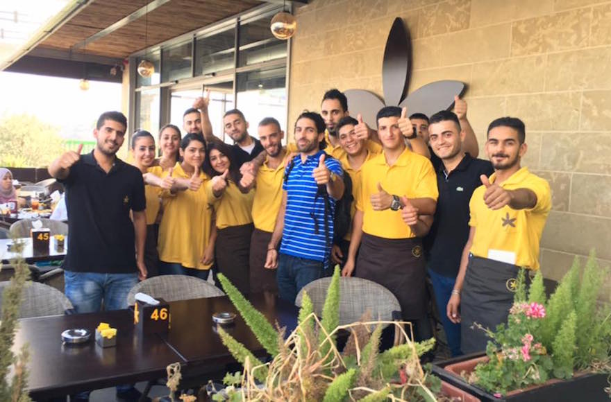 Owner John Saaden posing with members of his staff outside Jasmine Cafe in Nablus, West Bank. (Facebook)