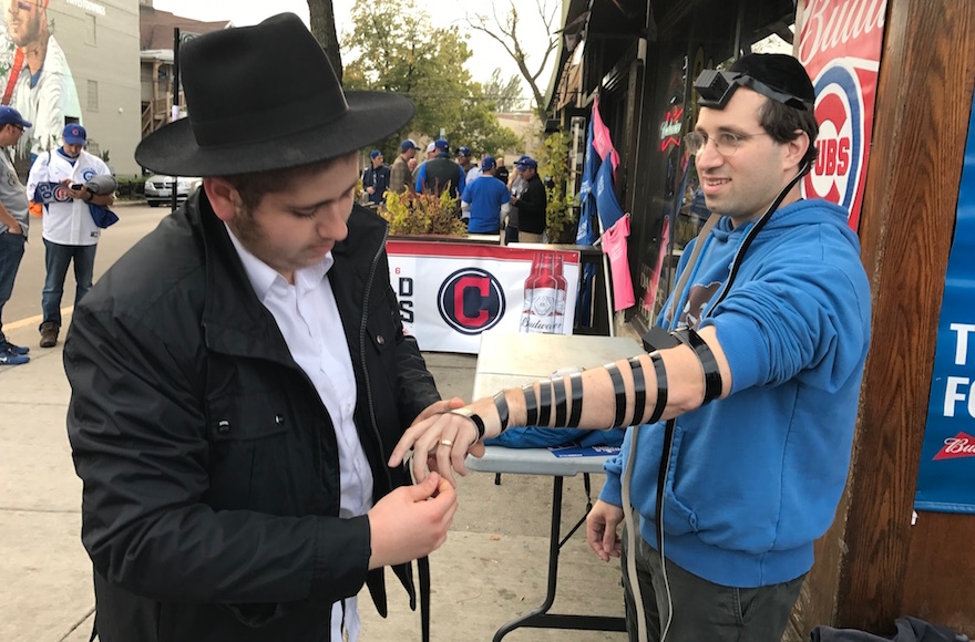 Ben Tolsky laying tefillin outside Wrigley Field. (Molly Tolsky)