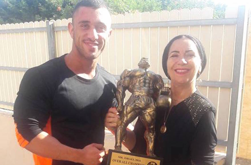 Kobi Yifrach, left, and his mother, Ruti Yifrach, holding the Mr. Israel trophy, 20 of Kobi Yifrach)