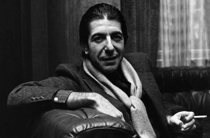 Leonard Cohen sharing a joke and smoking a cigarette in1980. (Evening Standard/Getty Images)
