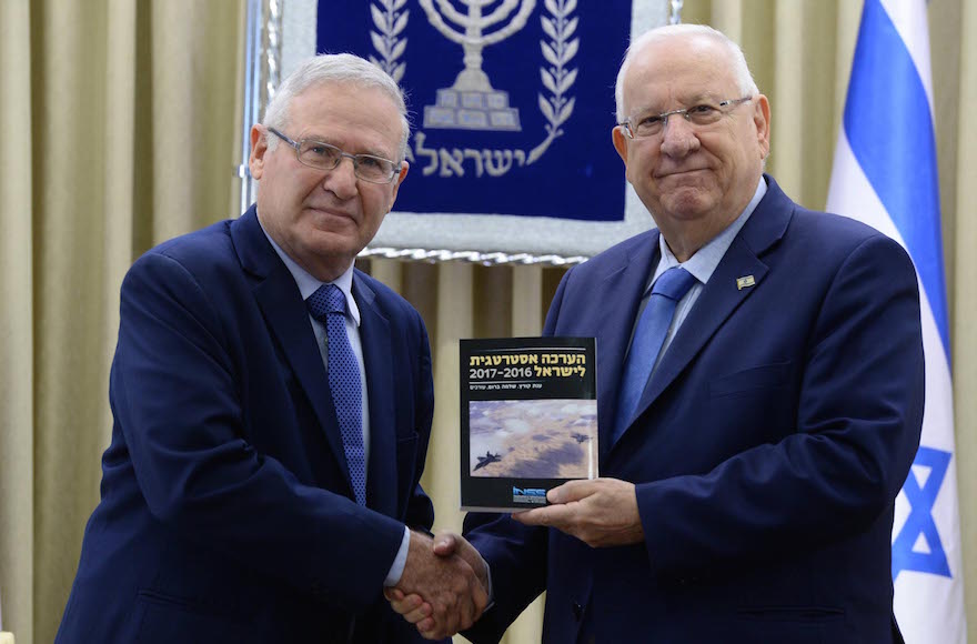 Institute for National Security Studies Chairman Amos Yadlin left, presenting Israeli President Reuven Rivlin with the 2017 strategic asssesment at the President's Residence in Jerusalem, Jan. 2, 2017. (Mark Neyman/GPO)