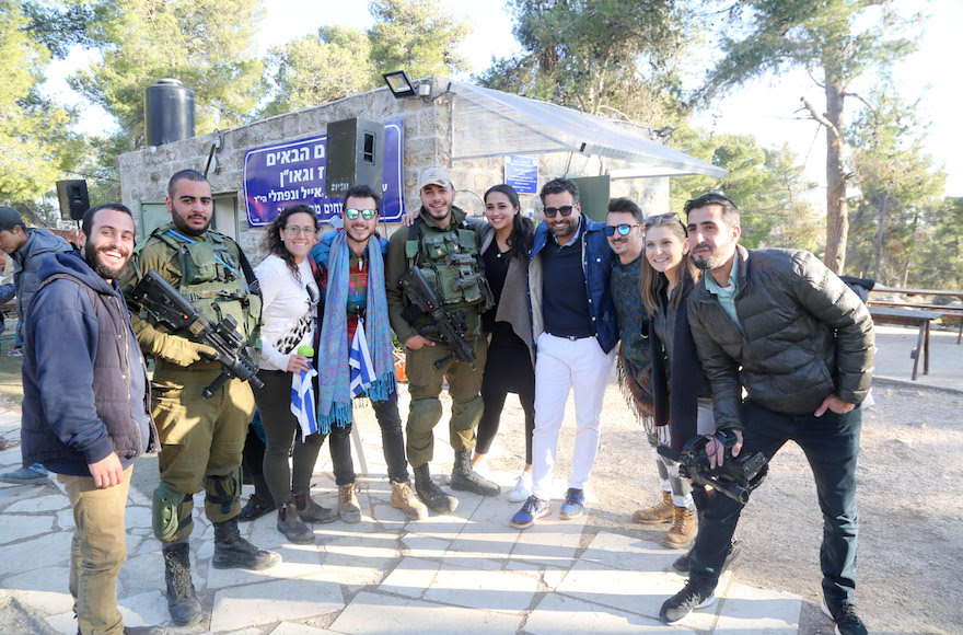 Joseph Waks, fourth from the right, posing with Jewish visitors and soldiers at the Oz Vegaon tent outpost in the West Bank, Jan. 2, 2017. (Courtesy of Avi Hyman Communications)