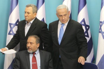 Israeli Foreign Minister Avigdor Liberman, sitting, with Defense Minister Ehud Barak, left, and Prime Minister Benjamin Netanyahu announcing a cease-fire with Hamas at a news conference in Jerusalem, Nov. 21, 2012. (Miriam Alster/Flash90)